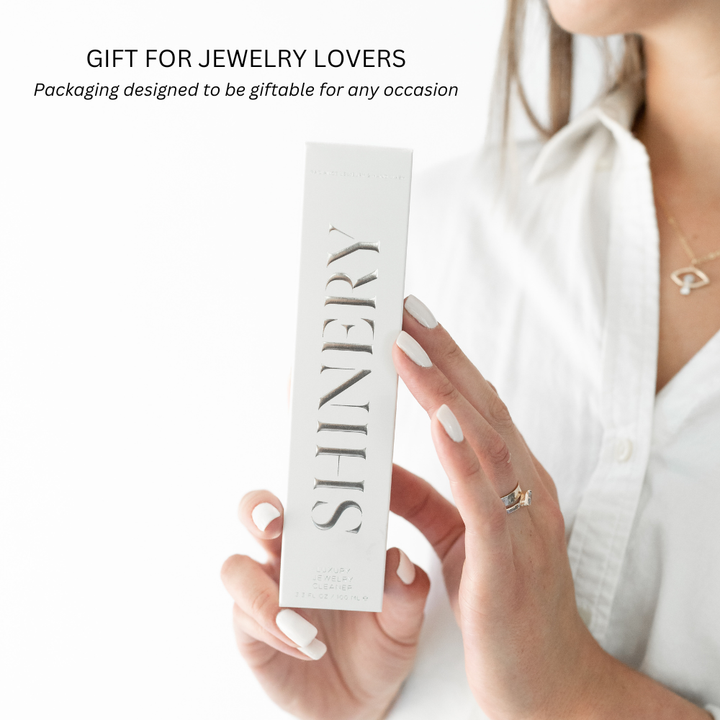 Hands holding the Shinery Jewelry Wash 