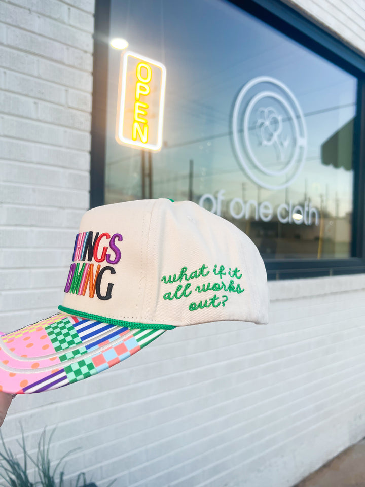 Colorful cap with text "What if it all works out"