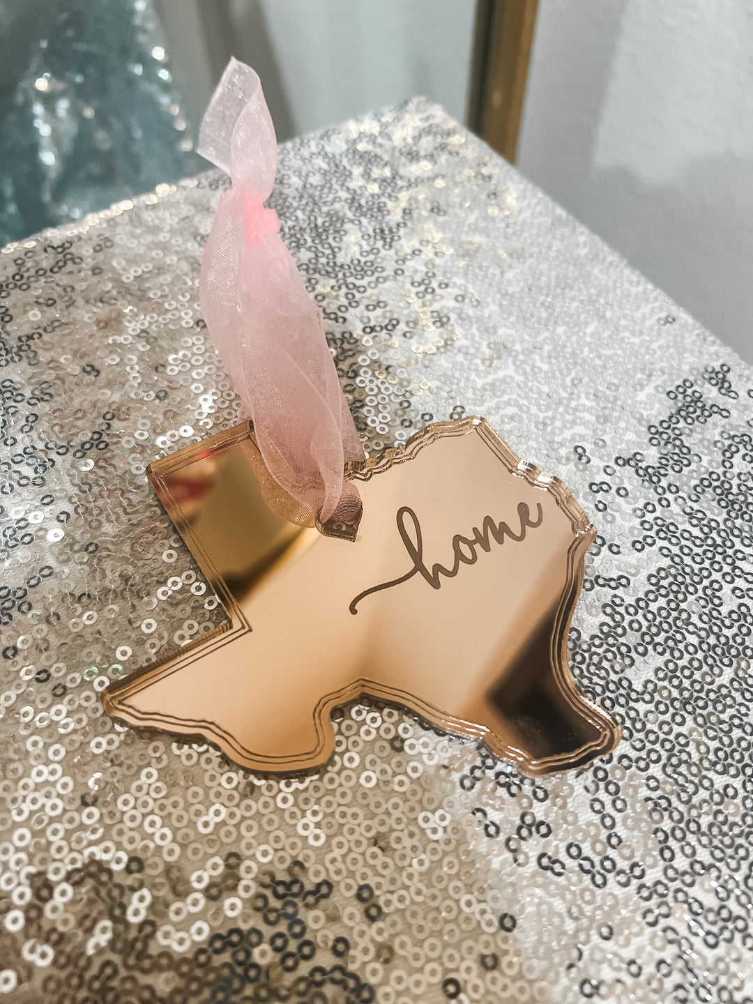 Rose gold acrylic Texas shaped Christmas ornament with 'home' text