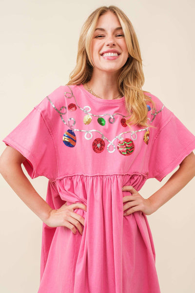 Woman wearing a pink dress with colorful decorations on a beige background