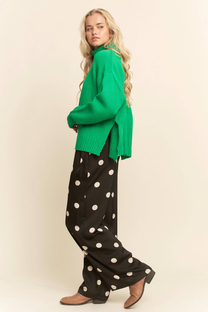 woman waring black pants with white polka dots