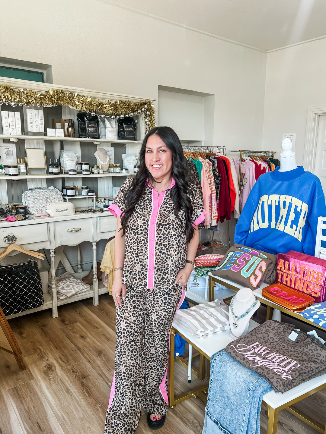 Woman in leopard set with pink accent stripe in boutique 