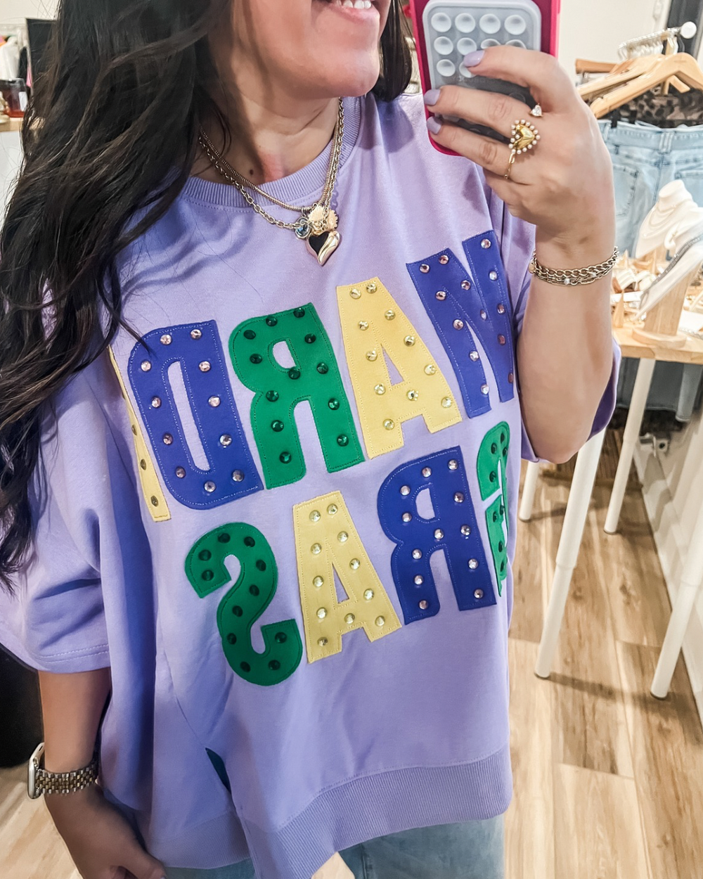 Womane's purple oversized shirt with "Mardi Gras" text