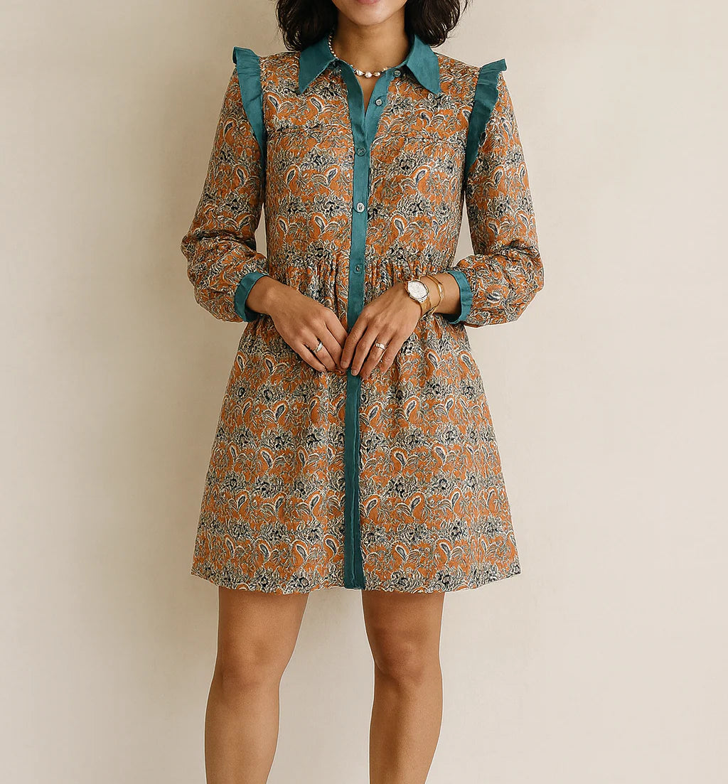 Woman wearing a fall dress with teal accents