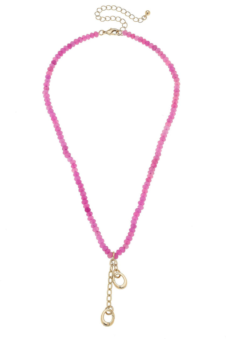 A pink beaded necklae with charm closures 
