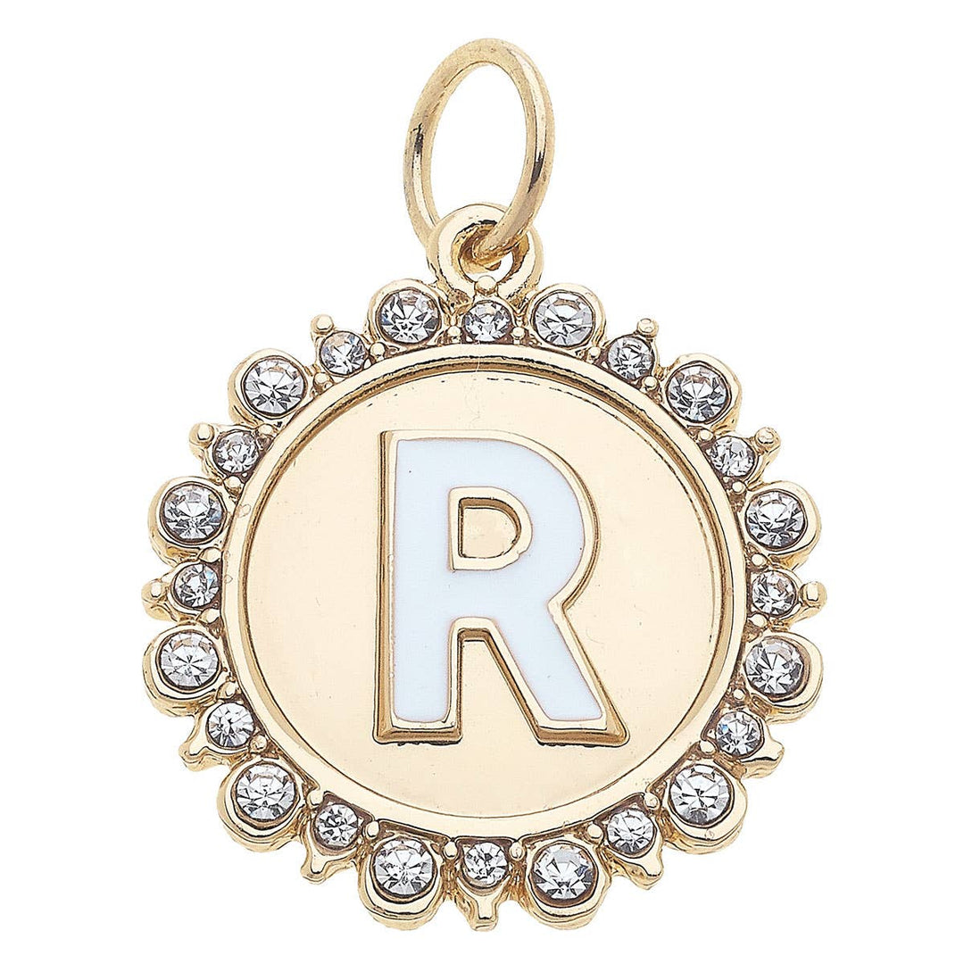 A shiny gold-colored disc charm with the letter R adorned with rhinestones around the edge.