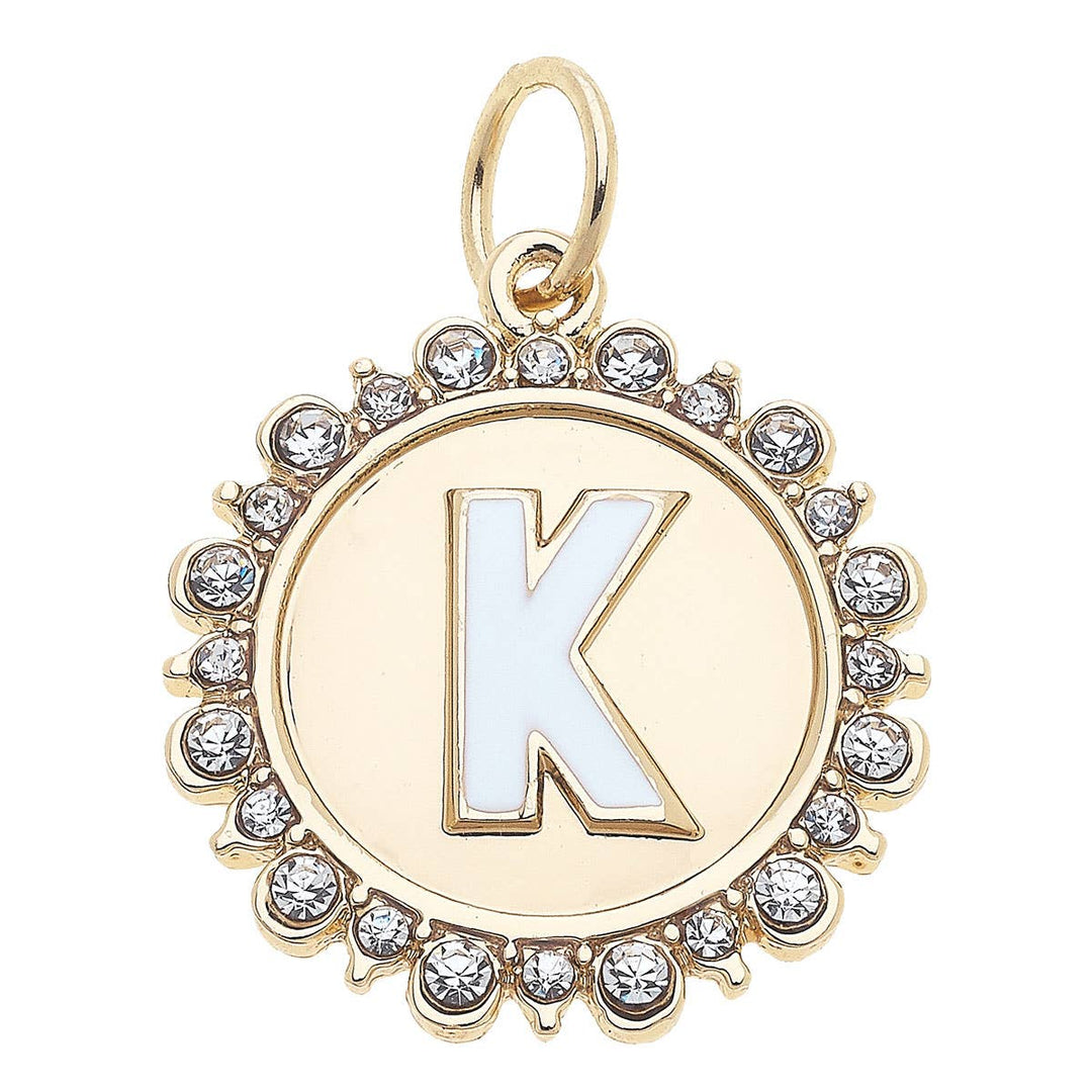 A shiny gold letter disc charm with the letter K studded with rhinestones.