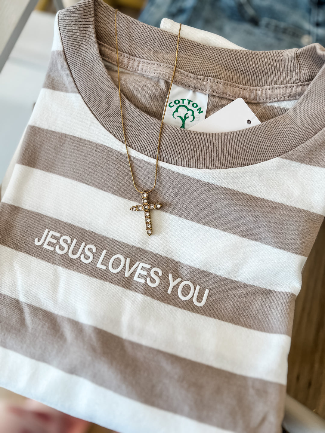 Striped shirt with 'Jesus Loves You' text 