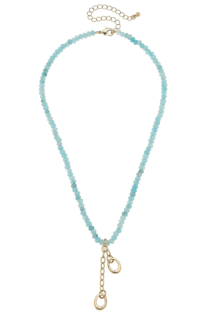 A light blue beaded necklace with a gold-plated adjustable length and a charm holder with a gold-plated clasp.