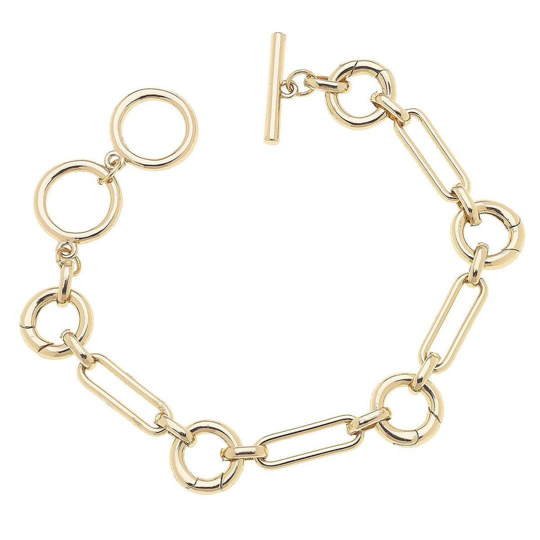 A shiny gold-plated toggle bracelet with multiple charm holders and hinge closures.