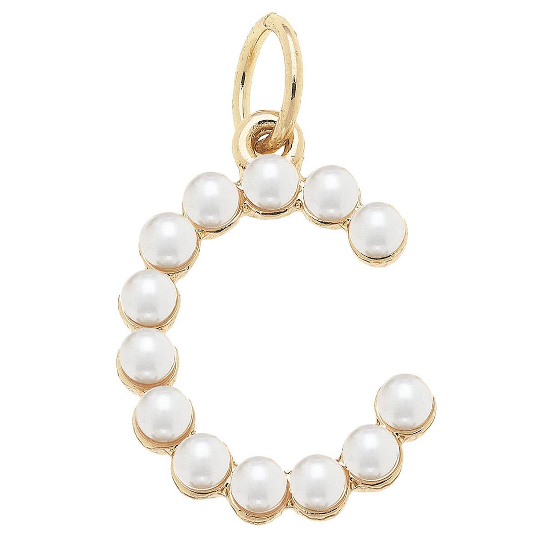 A gold-plated letter charm with ivory pearls studded on it.