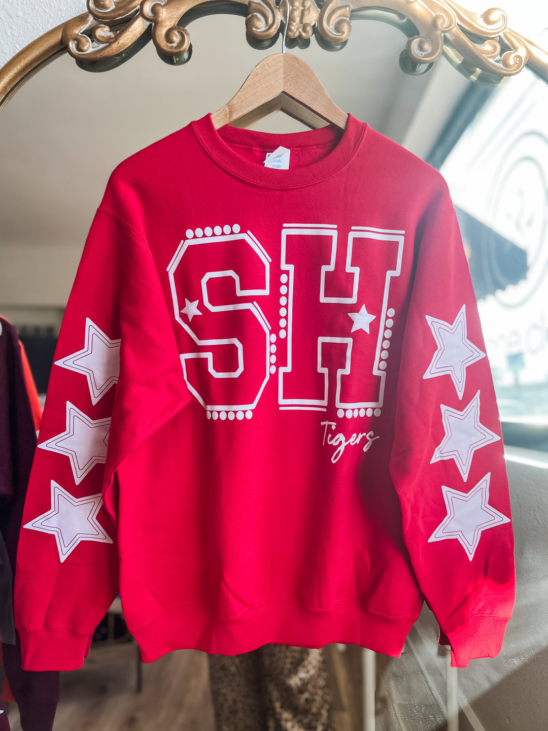 Red sweatshirt with 'SH Tigers' text and white stars
