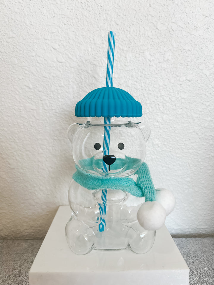 Clear bear-shaped glass with a blue lid and scarf