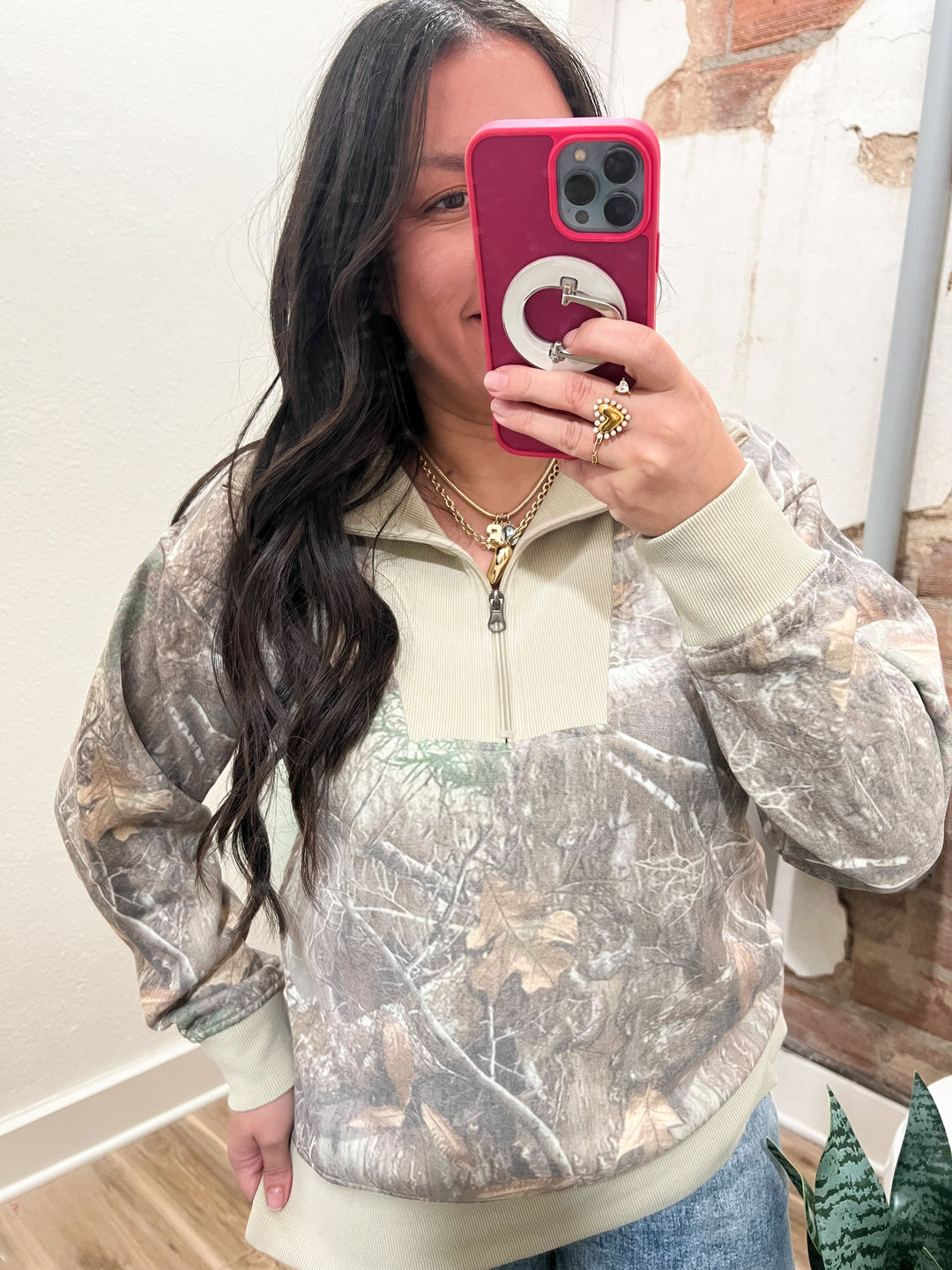 Woman wearing a camouflage half zip