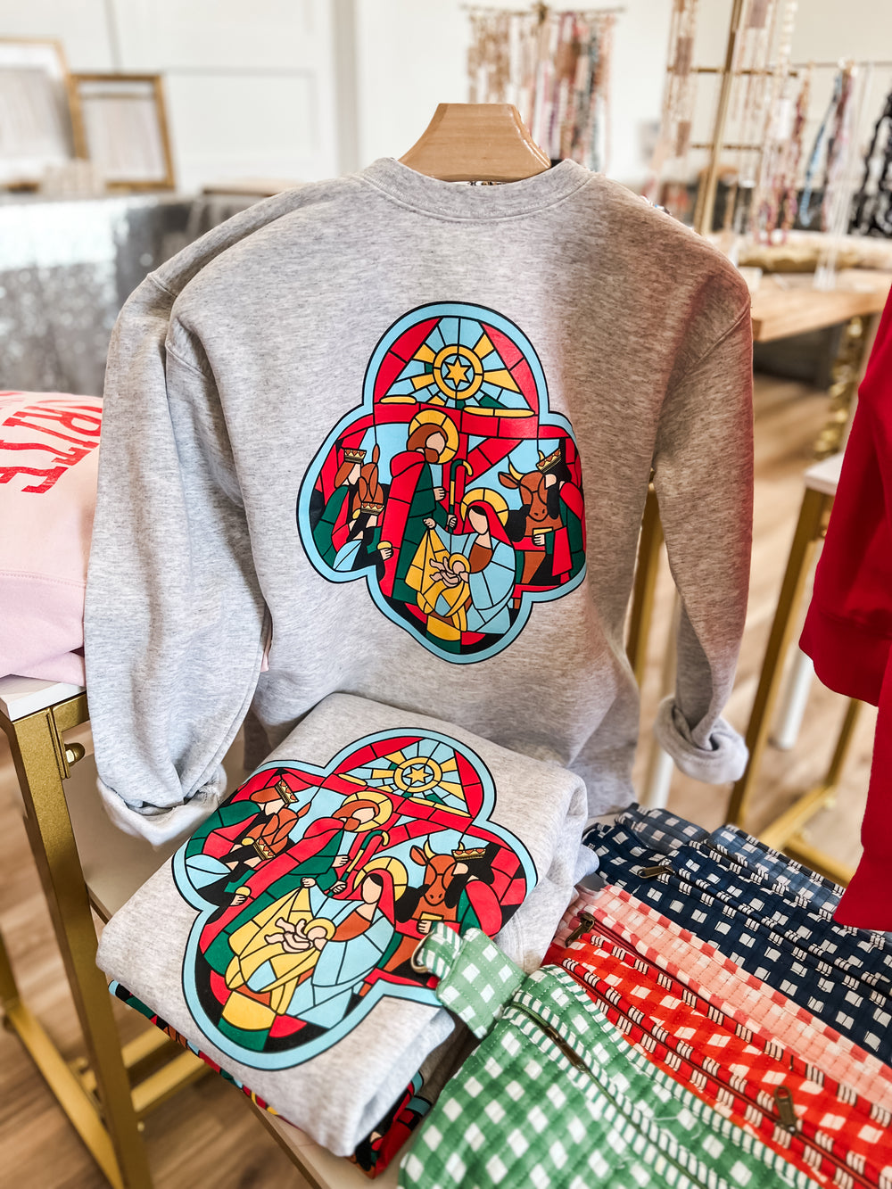 Grey sweatshirt with colorful stained glass nativity scene
