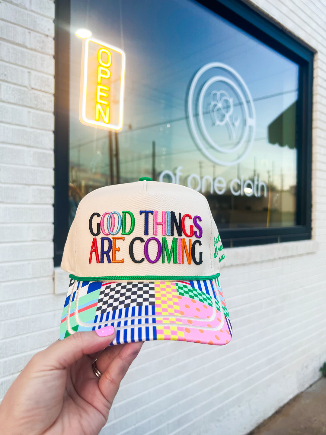 Colorful cap with 'Good Things Are Coming' text 