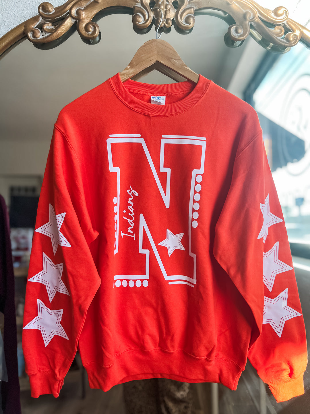 Red sweatshirt with white 'N' and 'Indians' and star design
