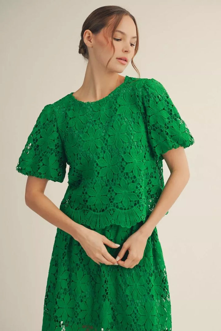 Woman wearing a green lace top 