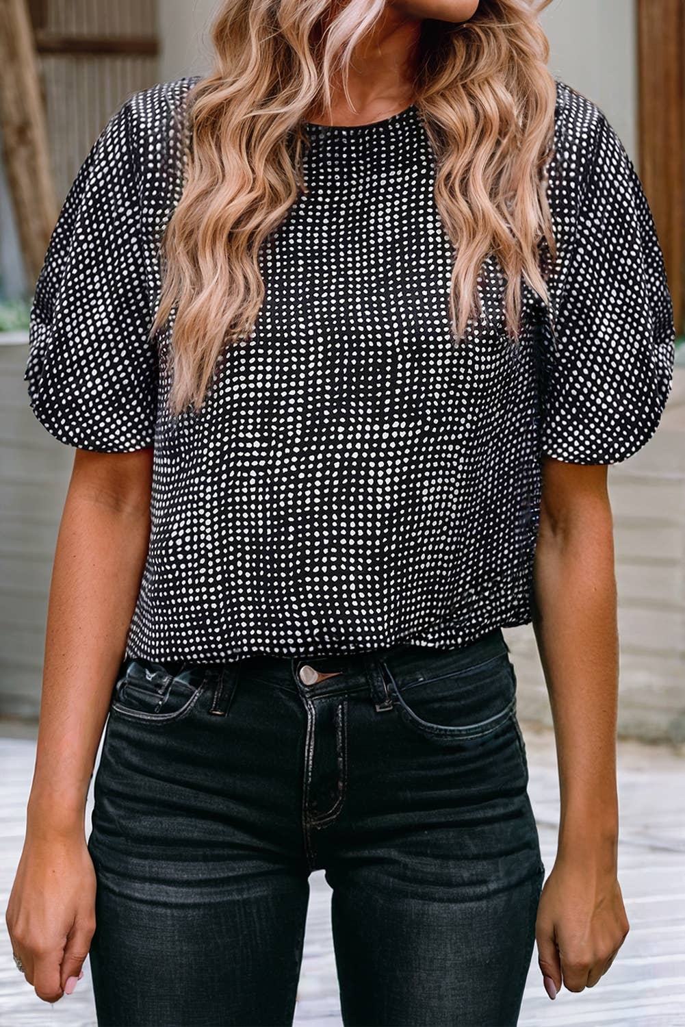 Woman wearing a black cheetah pattern shirt