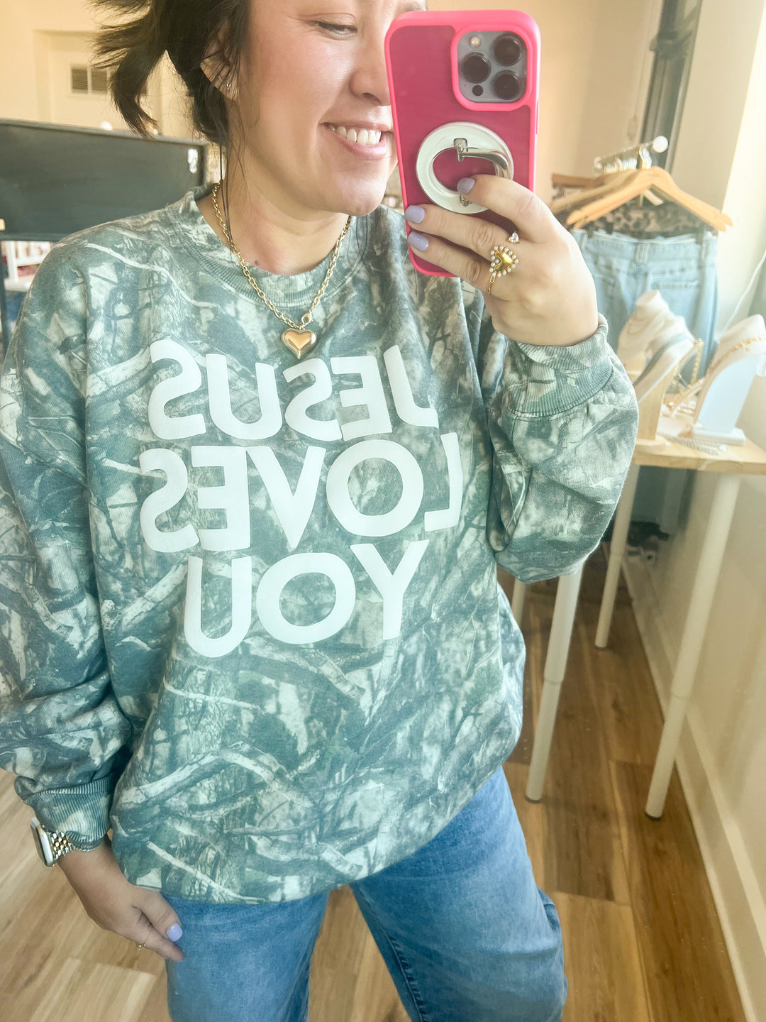 Came sweatshirt with "Jesus Loves You" text