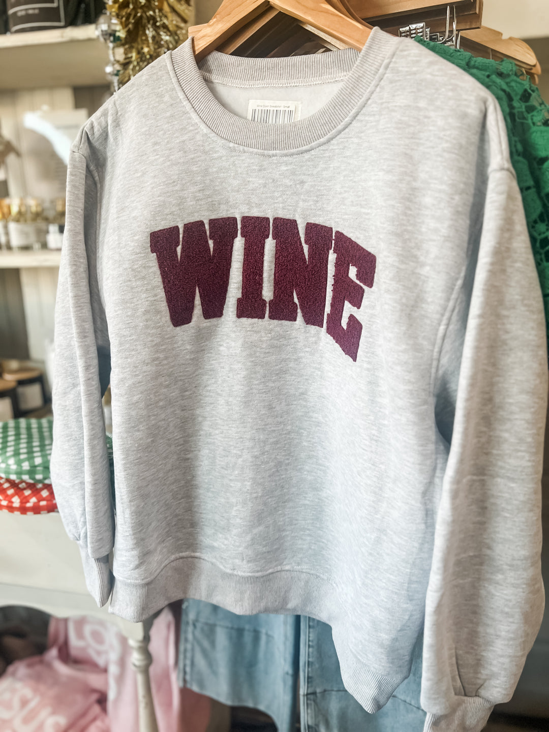 Gray sweatshirt with 'WINE' embroidered in maroon