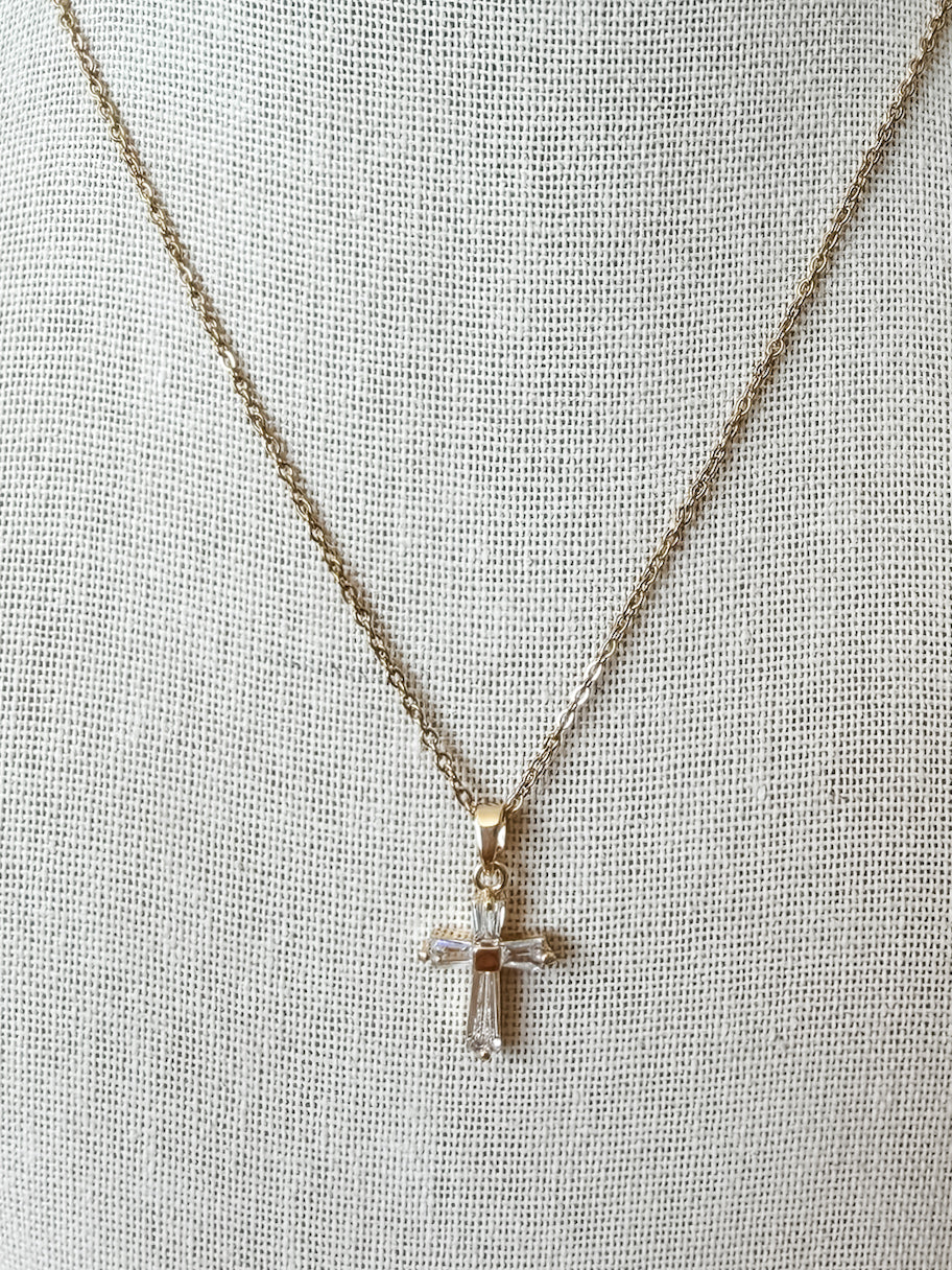 Cross pendant with baguette style crystal stones on a gold chain 