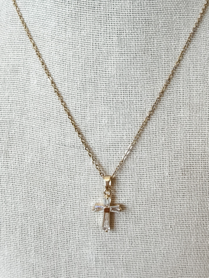 Cross pendant with baguette style crystal stones on a gold chain 