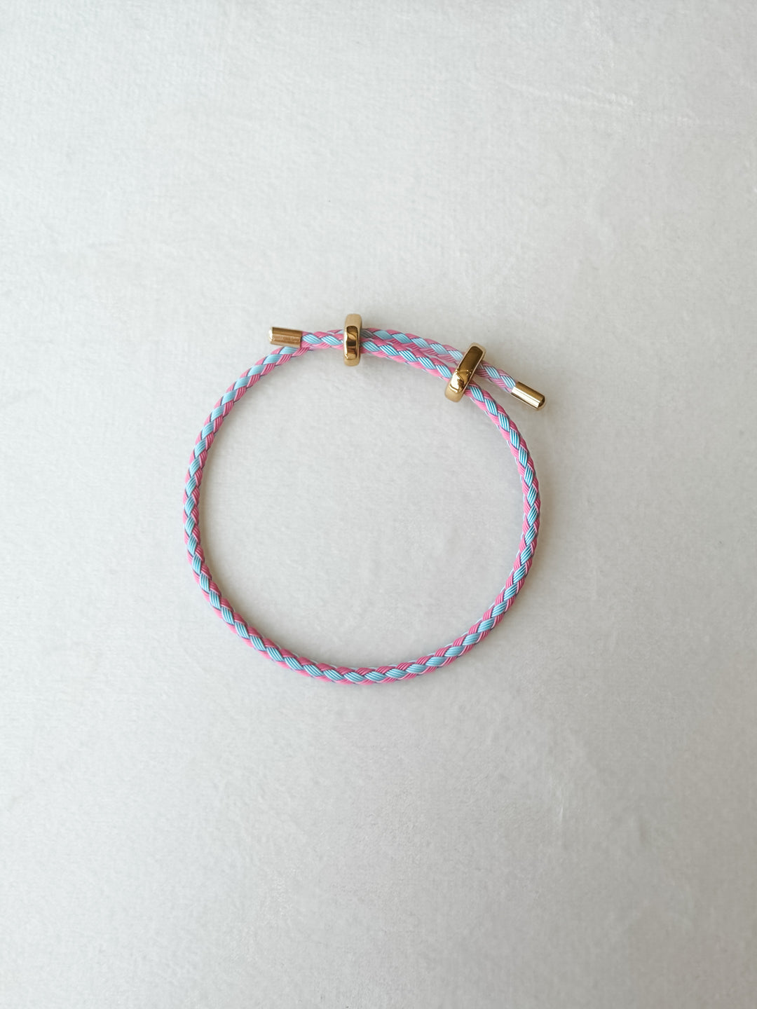 Blue and pink adjustable paracord bracelet with gold accents