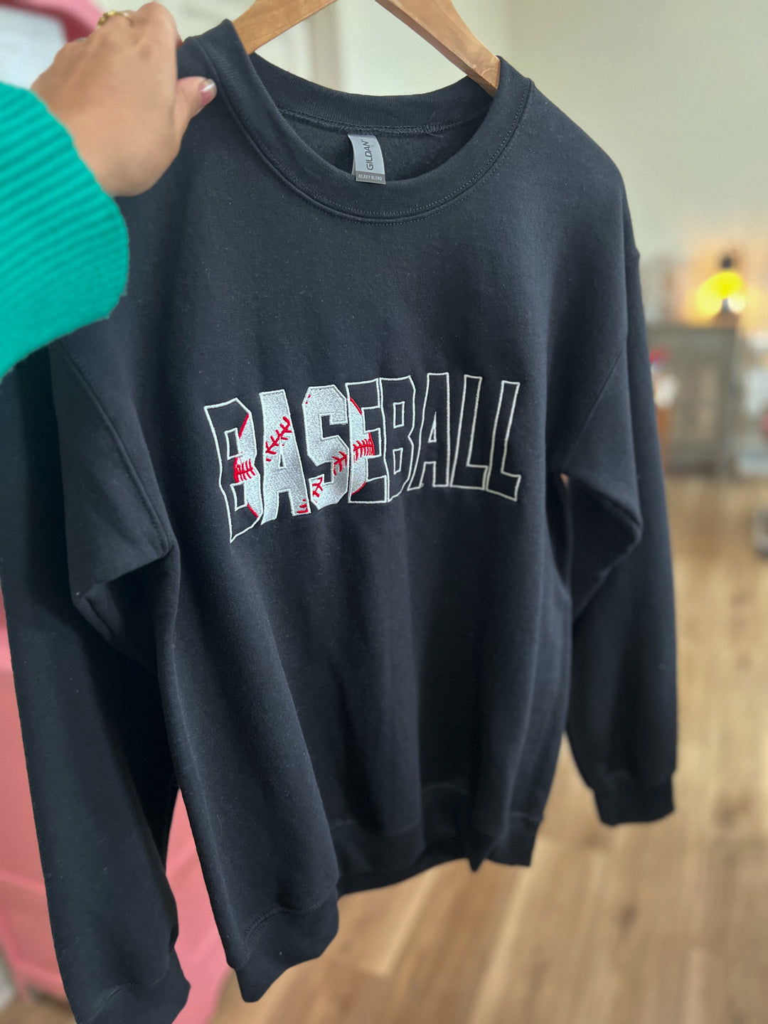 Black sweatshirt with 'BASEBALL' embroidered on it
