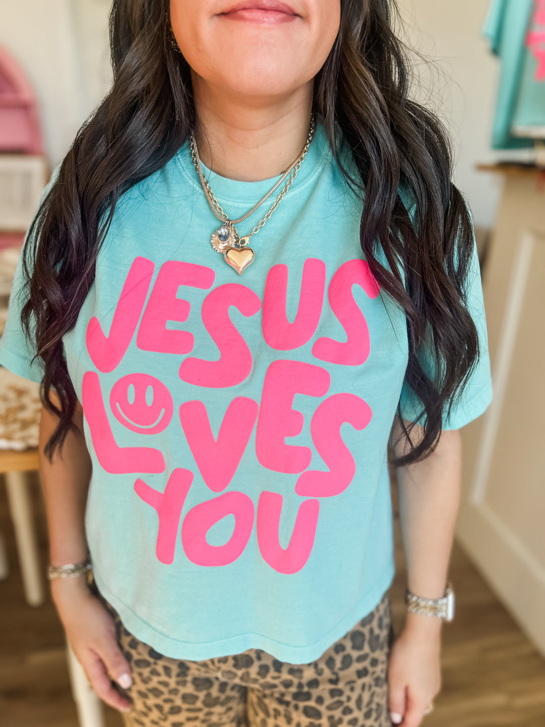 Woman wearing Christian Graphic tee with "Jesus Loves You"