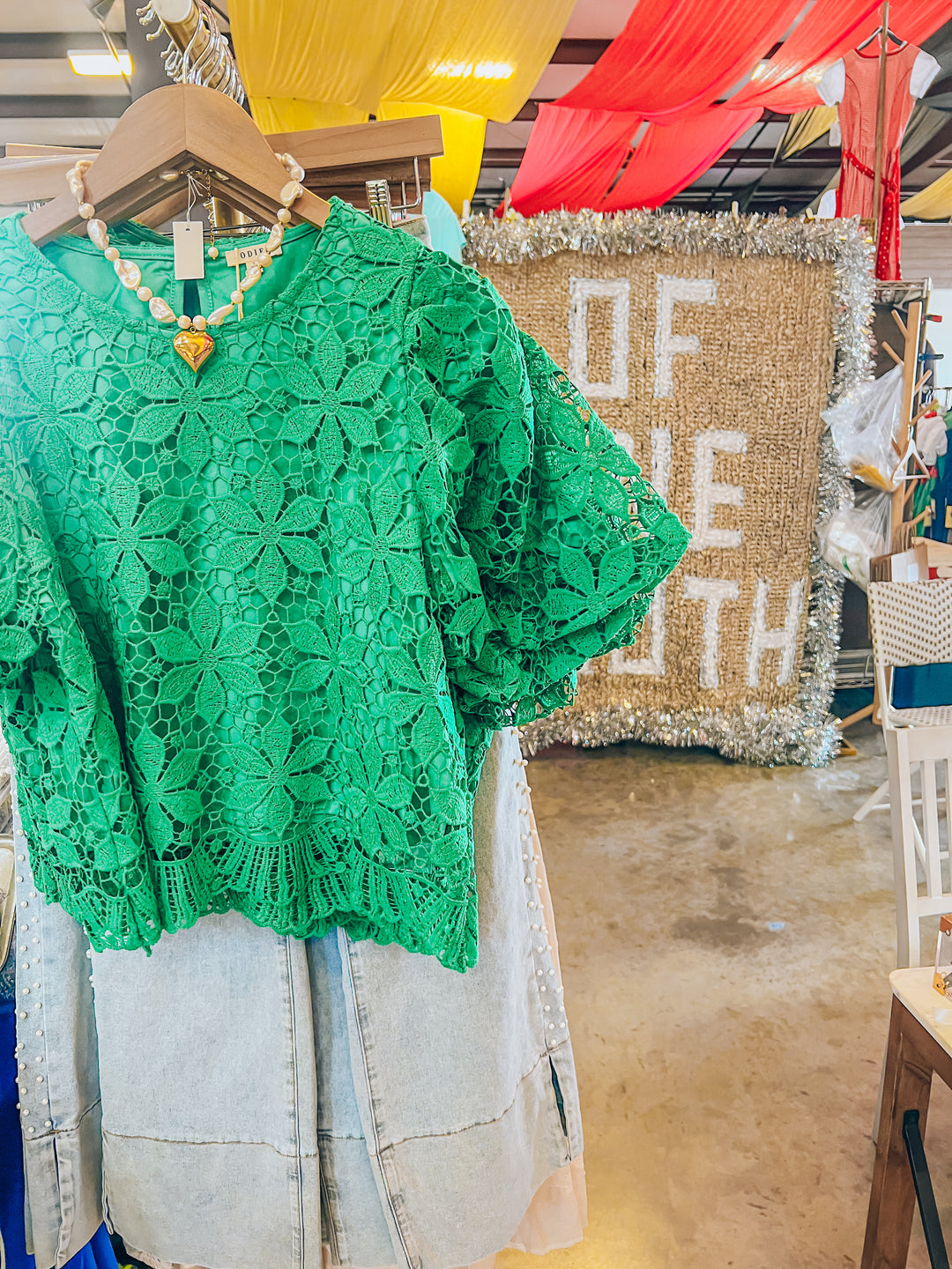 Green lace top with light washed jeans