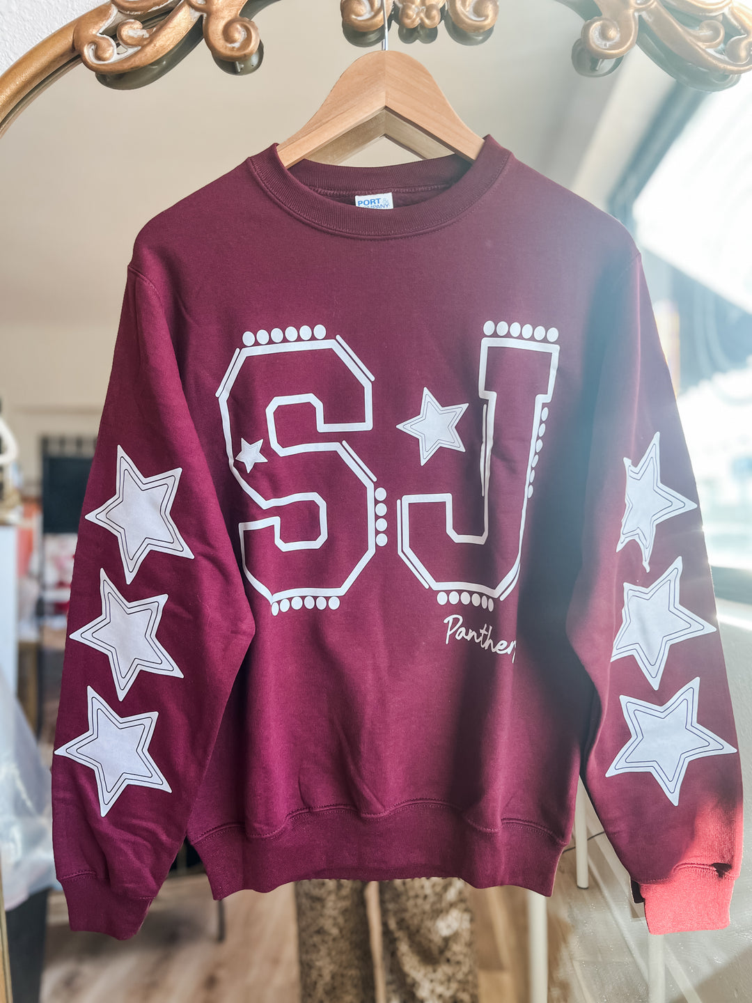 Maroon sweatshirt with 'SJ' and 'Panthers' lettering and star designs