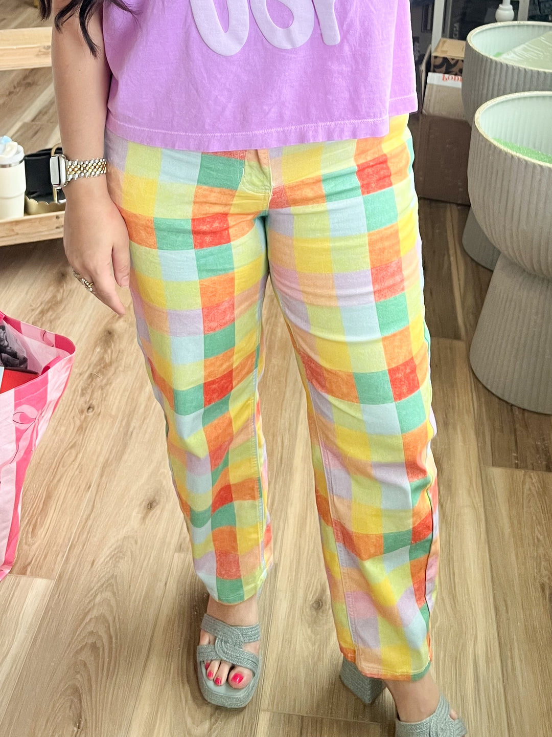 Woman wearing colorful plaid pants 