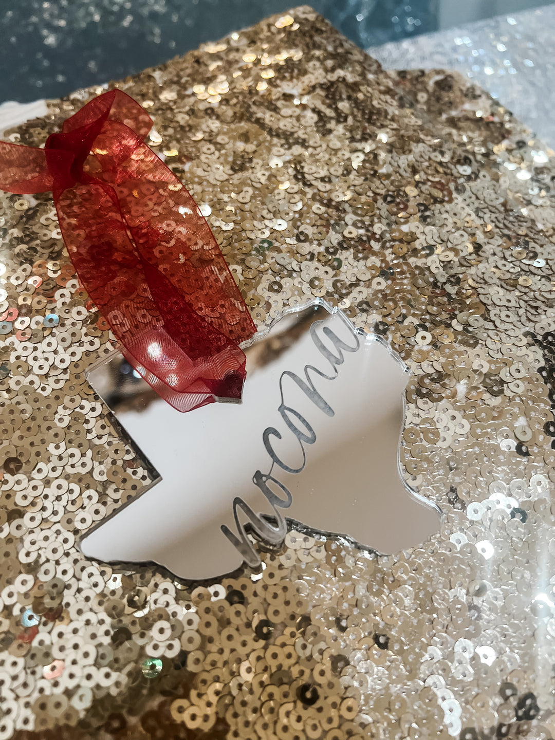 Silver acrylic Texas shaped Christmas ornament with 'Nocona' text