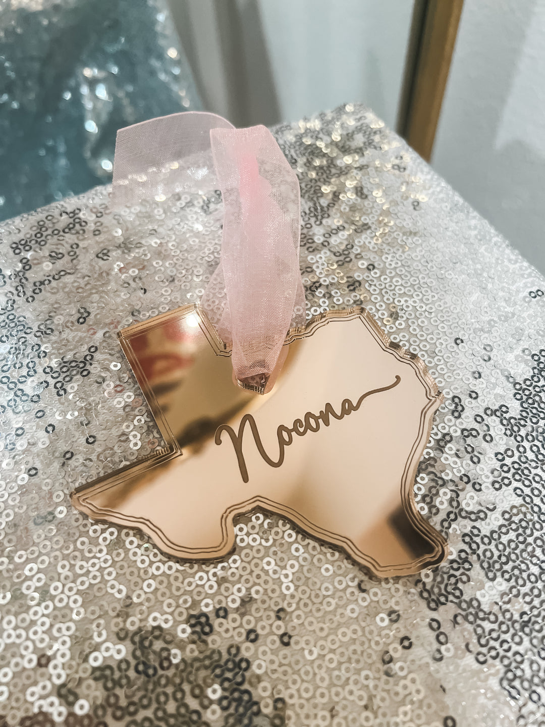 Rose gold state-shaped ornament with 'Nocona' engraving