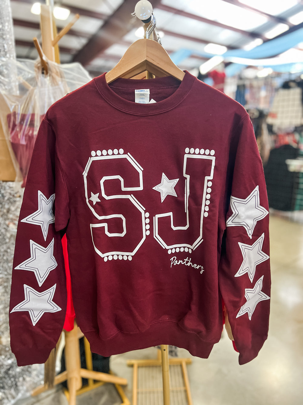 Maroon sweatshirt with 'SJ' and 'Panthers' lettering and star designs