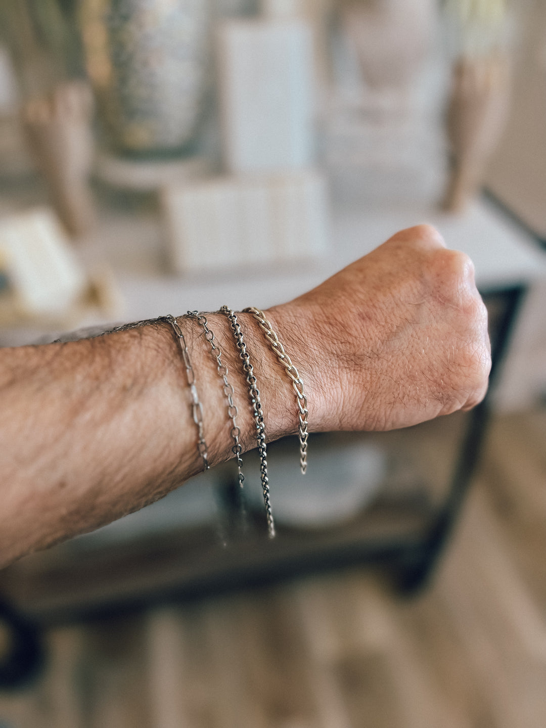 Man’s arm wearing permanent jewelry for men
