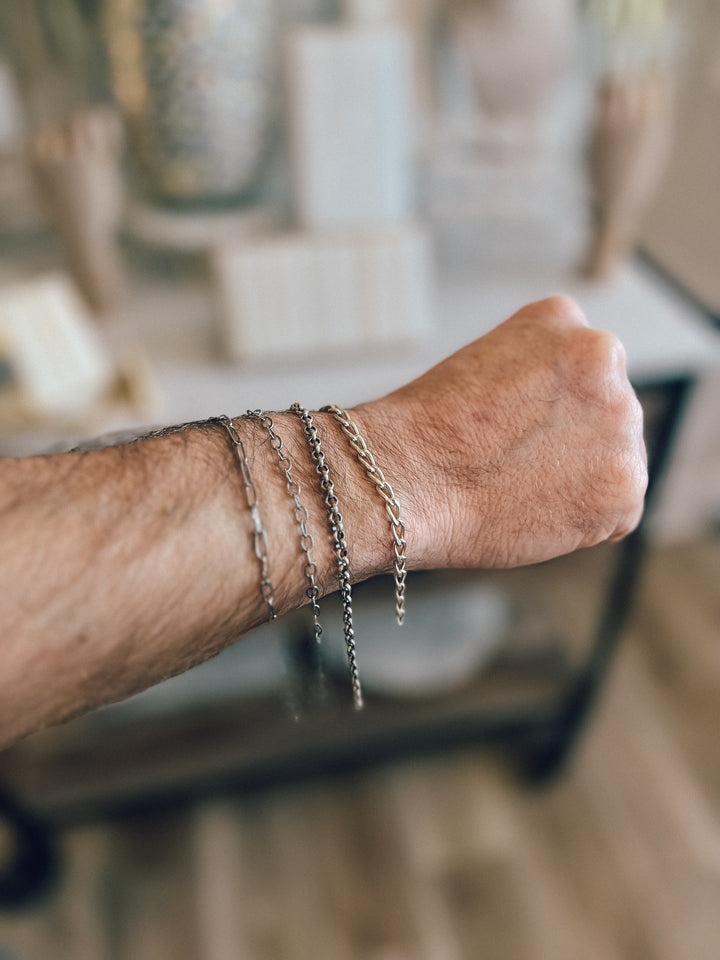 Man’s arm wearing permanent jewelry for men