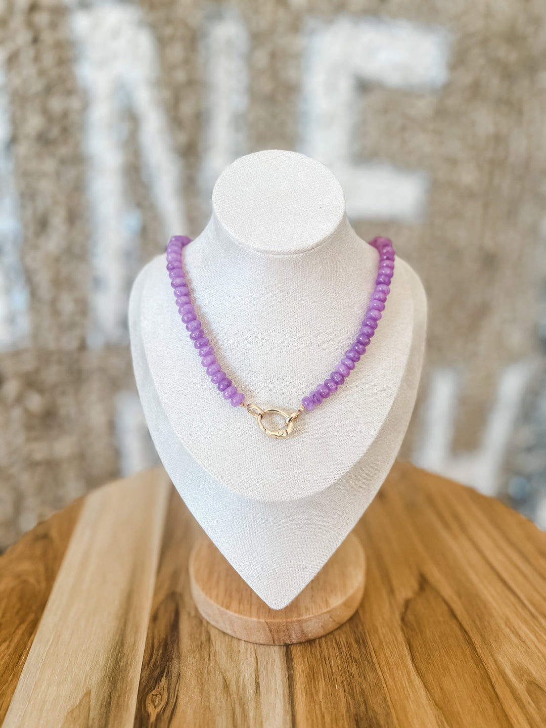 Purple beaded necklace with charm attachment