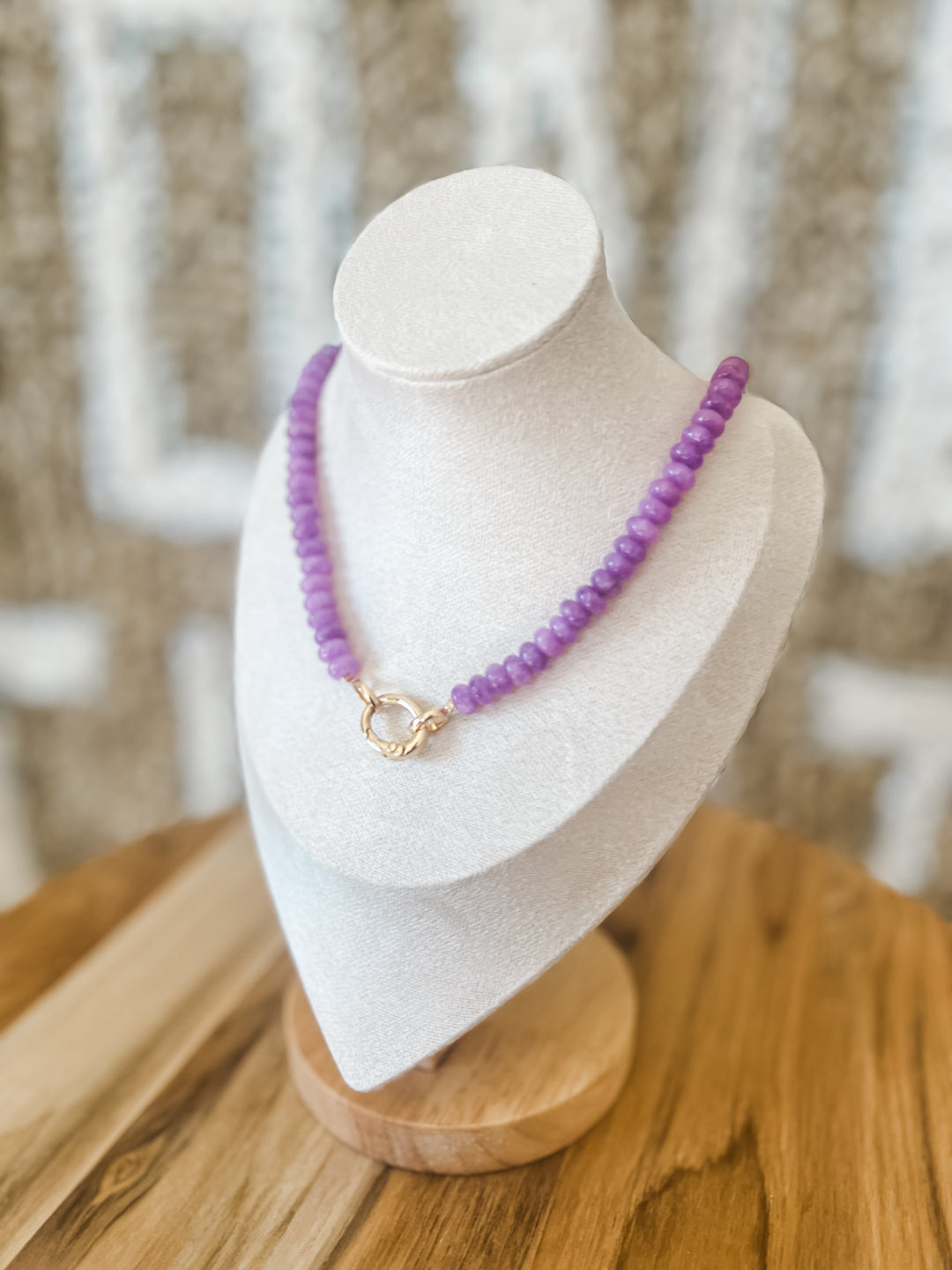 Purple beaded necklace with charm attachment