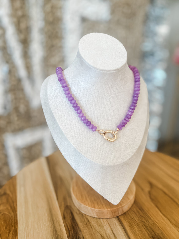 Video of purple beaded necklace with charm attachment