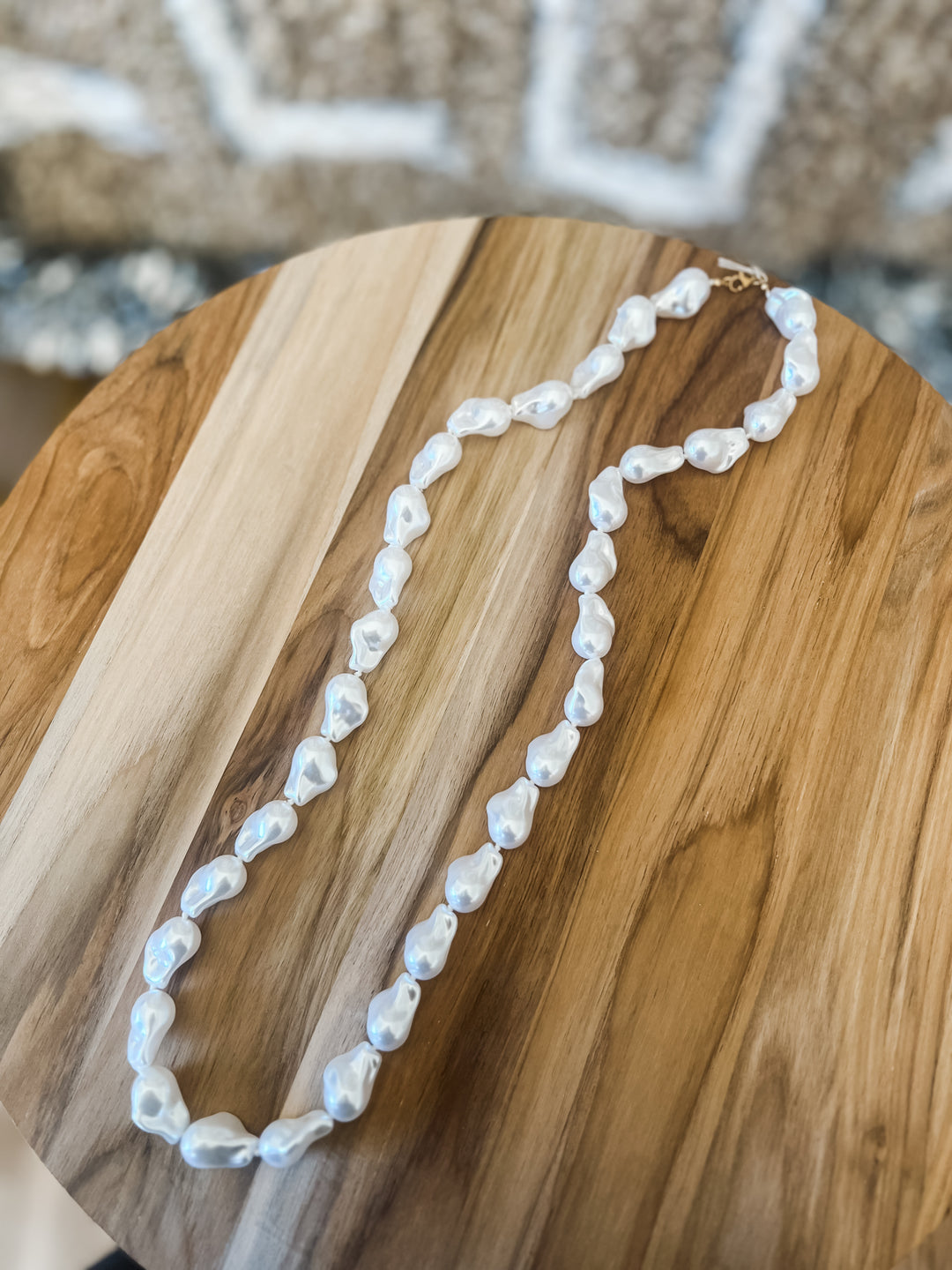 Pearl necklace on a wooden surface