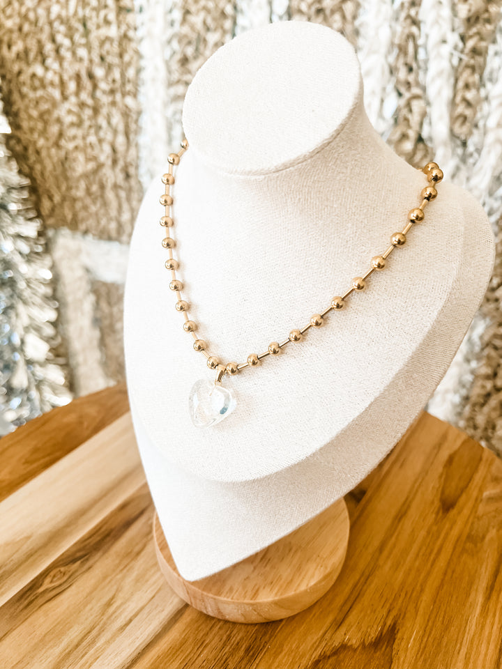 Gold necklace with clear heart pendant