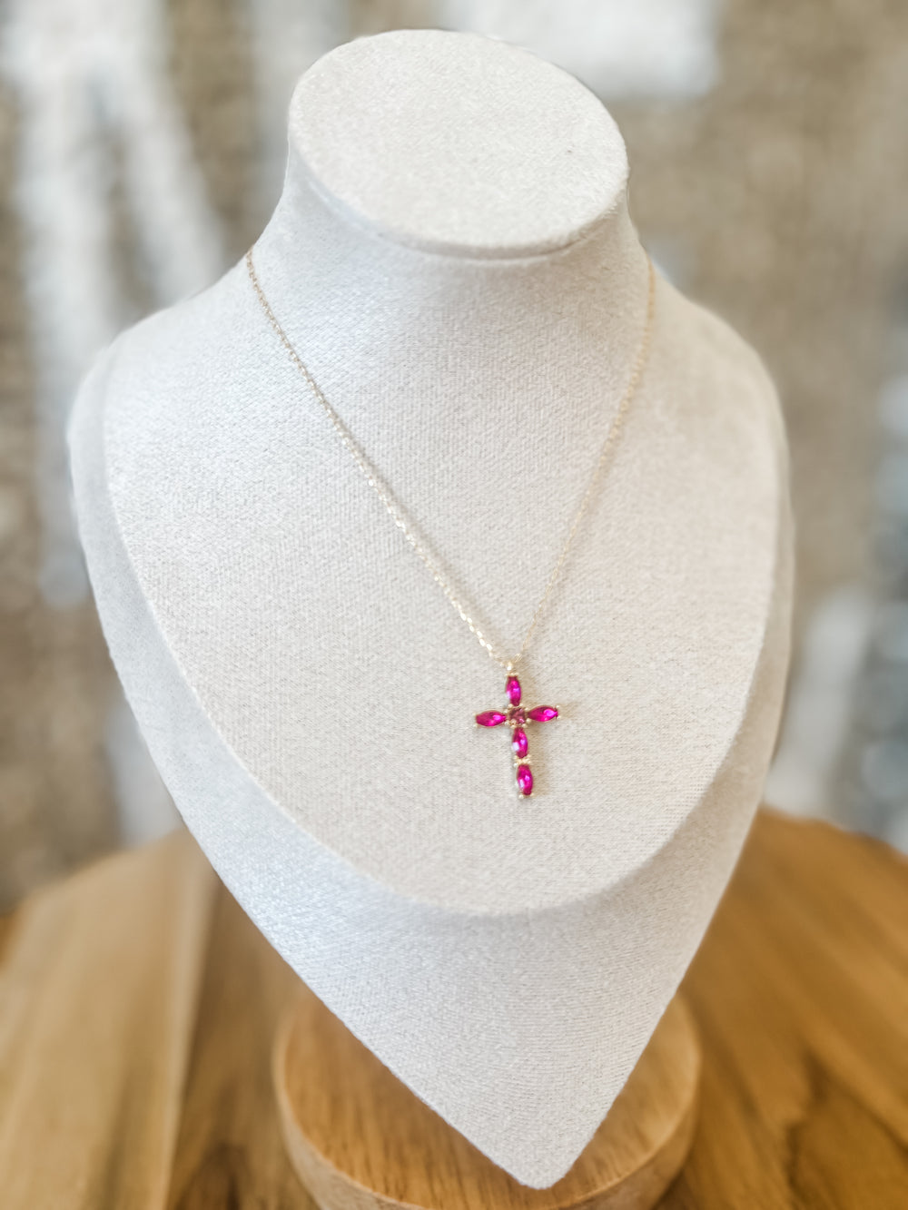 Gold necklace with fuchsia cross pendant