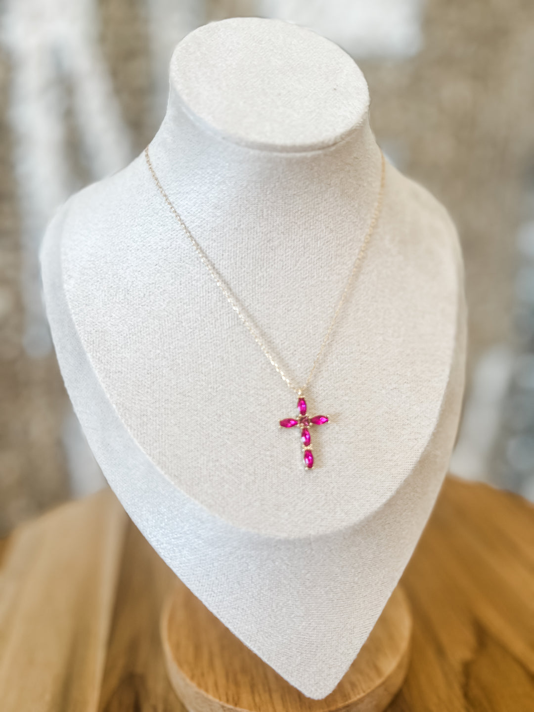 Gold necklace with fuchsia cross pendant