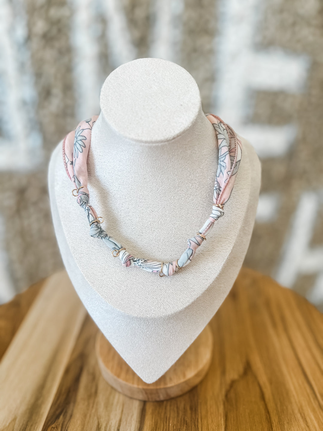 White and light pink cloth necklace with gold accents