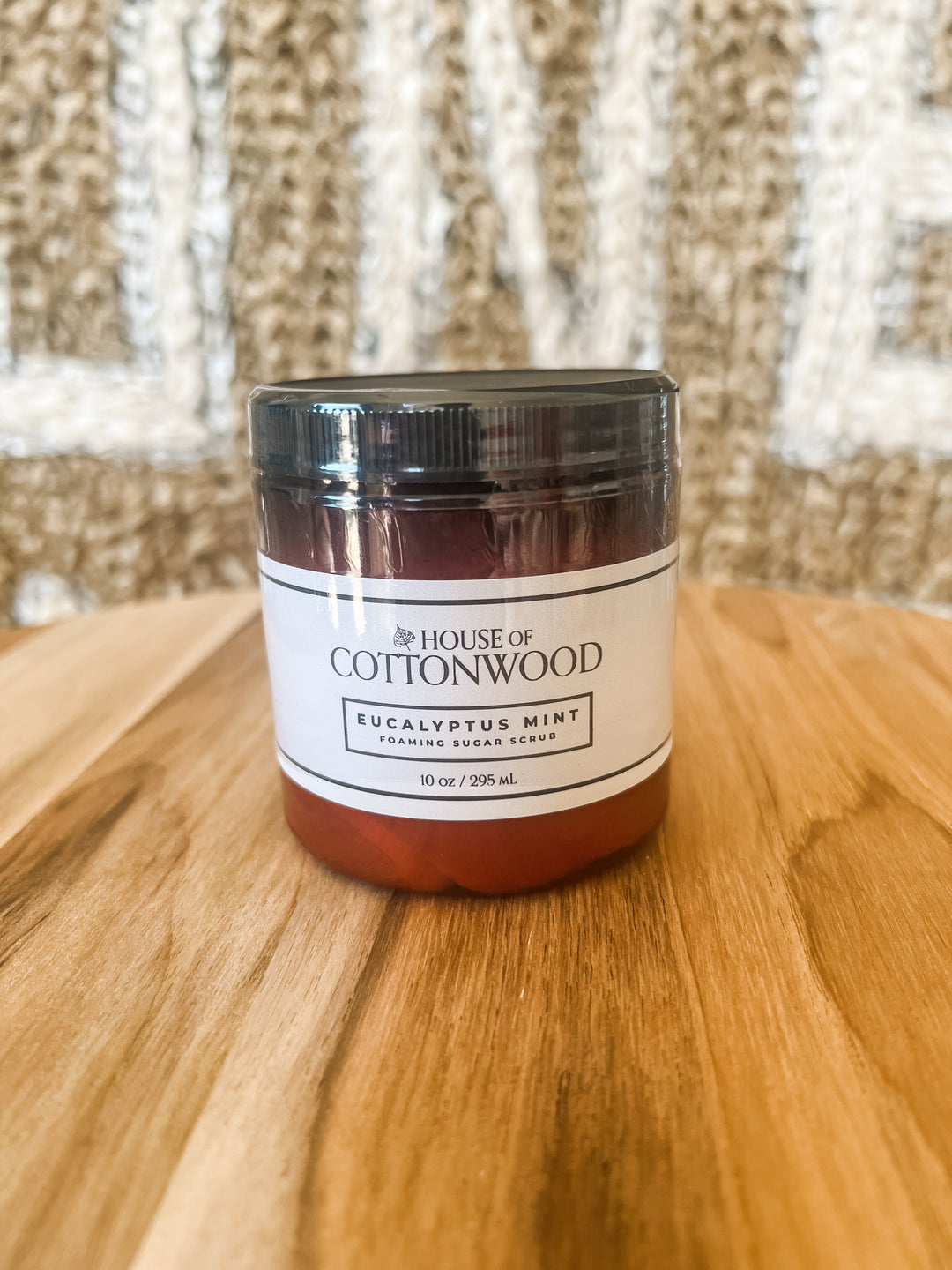 Jar of 'Eucalyptus Mint' body scrub on product from 'The House of Cottonwood' 