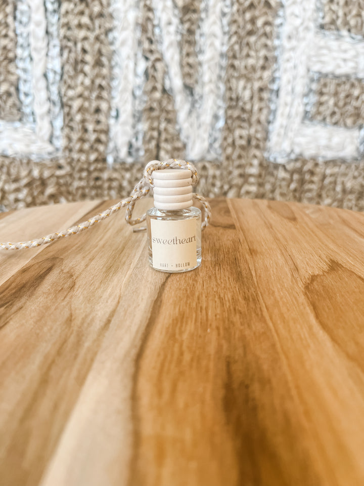 small bottle of car or air scent labeled &