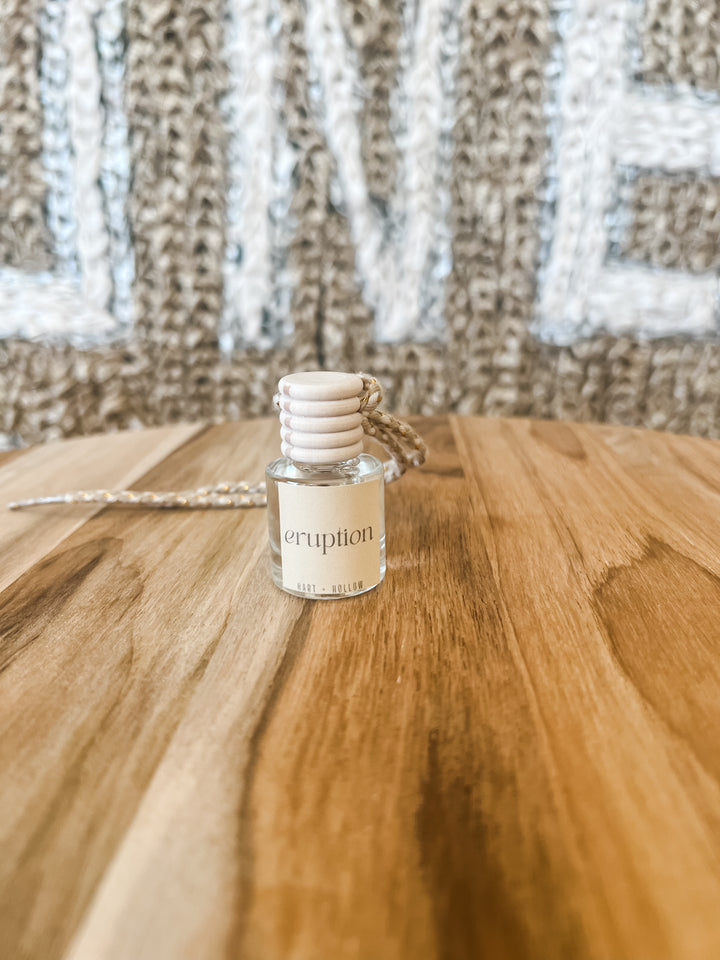 Small glass bottle of air or car scent labeled &