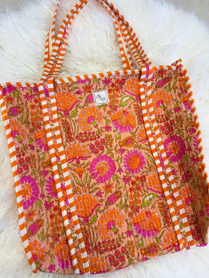 Floral patterned quilted bag with orange and pink design
